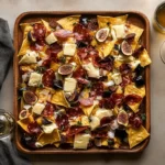 Charcuterie nachos with meats, cheeses, and gourmet toppings