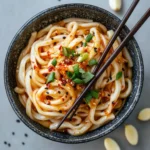chili garlic udon noodles in bowl
