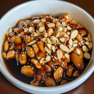 Chopped almonds and Asian sauce on rustic table