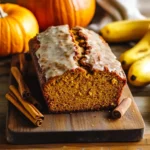 pumpkin banana bread sliced on rustic table