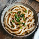 Vegan garlic udon noodles in a bowl